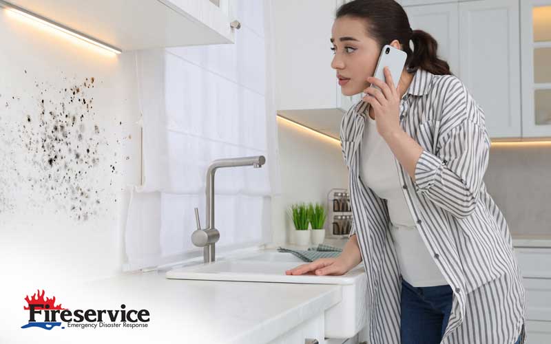 Woman calling Fireservice after noticing mold in her kitchen