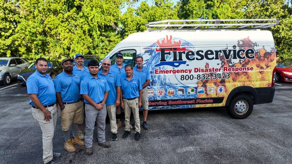 The Fireservice restoration team standing next to a business truck.