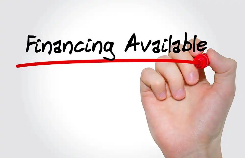 Hand holding a red marker drawing a red underline under the text "Financing Available."
