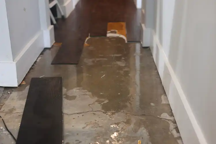 Partially demolished floor with standing water beneath it