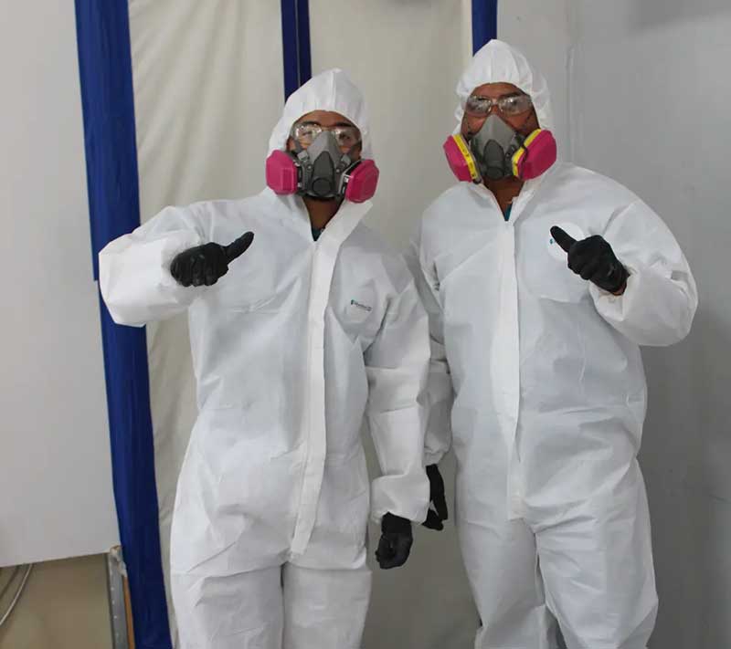 Two fire service employees dressed in jump suits